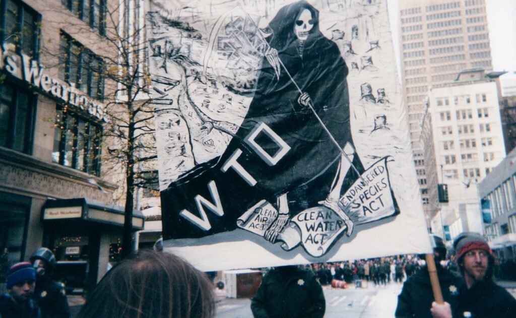 A huge banner showing the WTO as a grim reaper in front of a dying world at the 1999 Seattle protests